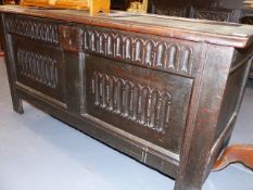 A 17th/18th.C. OAK COFFER WITH LOZENGE CARVED PANEL FRONT AND FRIEZE. W.125cms.