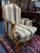 A PAIR OF FRENCH LOUIS XV STYLE CARVED ARMCHAIRS COVERED IN TRIBAL STYLE FABRIC.