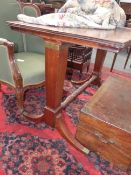 A REGENCY AND LATER MAHOGANY RISING TOP DRAWING TABLE WITH TRESTLE SUPPORTS, SABRE LEGS ENDING IN