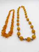 TWO ROWS OF AMBER BEADS, ONE BEING A GRADUATED IRREGULAR SHAPE,APPROXIMATE LENGTH 62cms ,APPROXIMATE