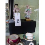 TWO POLYCHROME PORCELAIN FIGURES OF A BOY AND GIRL IN THE MANNER OF MEISSEN AND TWO MINIATURE CUPS