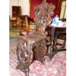 A 19th.C.ITALIANATE CARVED WALNUT HALL CHAIR WITH MYTHOLOGICAL FIGURE SUPPORTS AND CARVED GRIFFIN