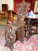 A 19th.C.ITALIANATE CARVED WALNUT HALL CHAIR WITH MYTHOLOGICAL FIGURE SUPPORTS AND CARVED GRIFFIN