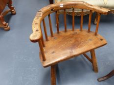 AN ANTIQUE PRIMITIVE ELM SEAT LOW BACK ARMCHAIR.