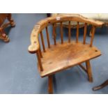 AN ANTIQUE PRIMITIVE ELM SEAT LOW BACK ARMCHAIR.