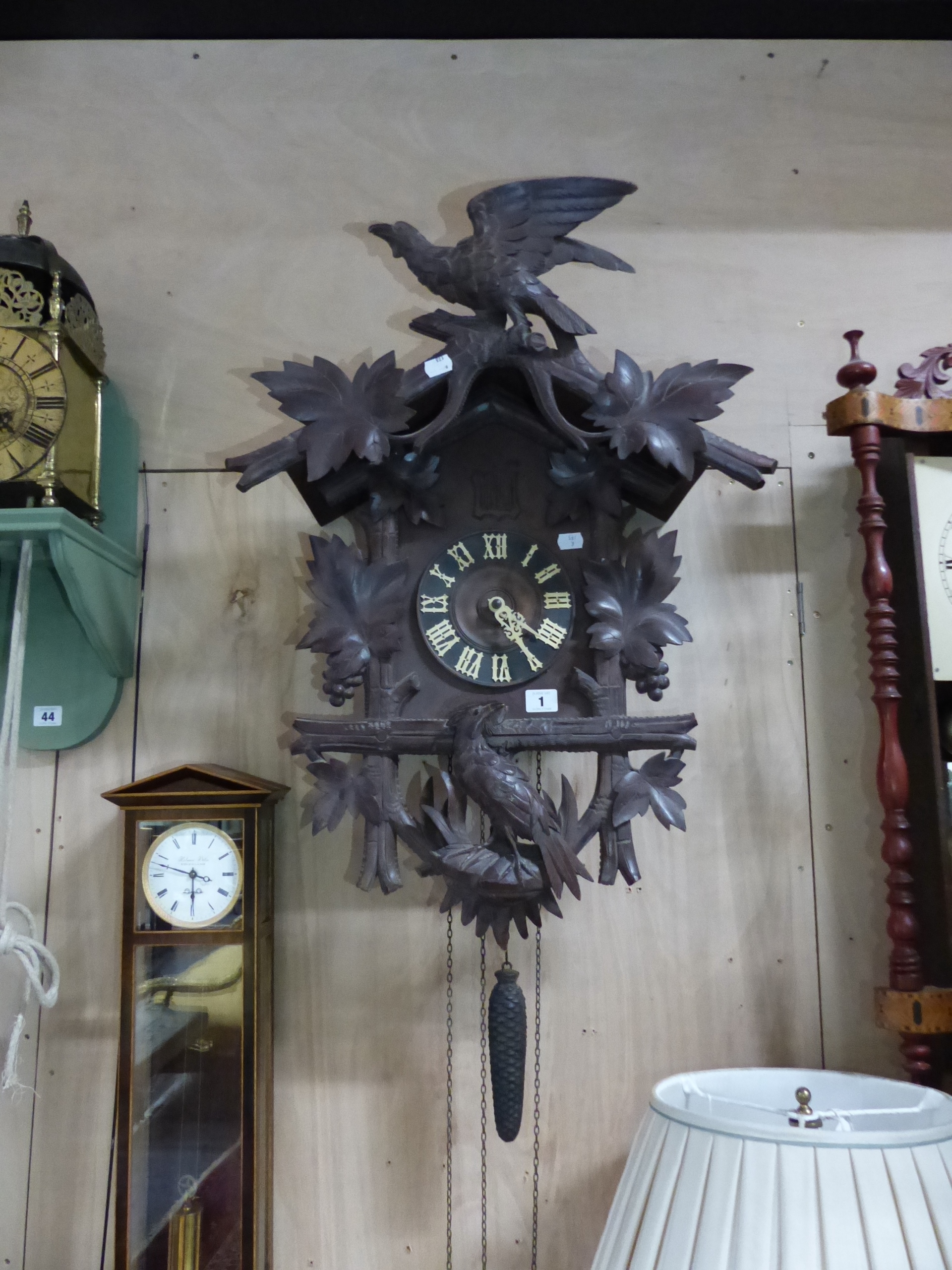 AN EARLY 20th.C.BLACK FOREST CARVED CASE CUCKOO WALL CLOCK. H.70 x W.50cms.