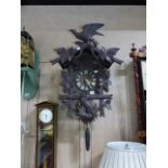 AN EARLY 20th.C.BLACK FOREST CARVED CASE CUCKOO WALL CLOCK. H.70 x W.50cms.