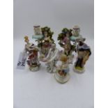A MEISSEN FIGURE OF CUPID. H.11cm. TOGETHER WITH A PAIR OF BOCAGE FIGURAL CANDLESTICKS AND THREE