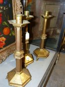 THREE BRASS ARTS AND CRAFTS PUGINESQUE ALTAR CANDLESTICKS. H.42cms.