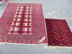 AN ORIENTAL RUG OF TURKOMAN DESIGN. 201x151cms TOGETHER WITH A SMALL TEKKE BOKHARA RUG.