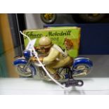 A SCHUCCO TINPLATE CLOCKWORK TOY MOTORCYCLE AND RIDER, PATENT MOTO-DRILL 1006. COMPLETE WITH BOX.