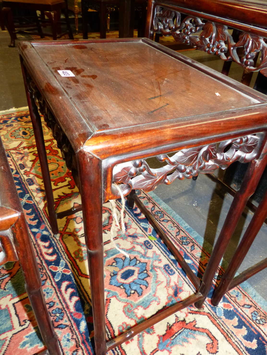 A NEST OF FOUR CHINESE CARVED HARDWOOD TABLES WITH PIERCED FOLIATE APRONS. - Image 9 of 19