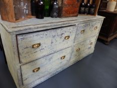 AN ANTQUE LARGE PAINTED PINE SHOP COUNTER FITTED WITH FOUR DEEP DRAWERS AND INSET MEASURING RULE.