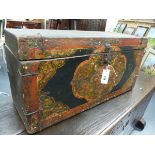 AN ORIENTAL POLYCHROME DECORATED AND IRON MOUNTED TRUNK, THE FRONT WITH A DRAGON MASK FRAMED BY