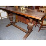 A GOOD 17th.C.STYLE OAK REFECTORY TYPE TABLE WITH PLANK TOP OVER CARVED BALUSTER SUPPORT AND TRESTLE