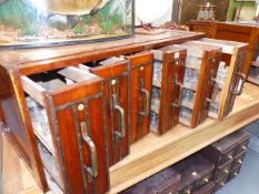 AN UNUSUAL PAIR OF SPECIMEN CHESTS, EACH WITH SIX TIERED DRAWERS FITTED WITH BOTTLES, LABELLED- "