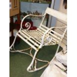 A VICTORIAN WROUGHT IRON GARDEN ROCKING CHAIR TOGETHER WITH A LATER CAST METAL LOW TABLE.