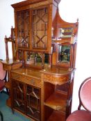 A CARVED AND INLAID MAHOGANY EDWARDIAN INVERTED BREAKFRONT DISPLAY CABINET WITH ASTRAGAL GLAZED