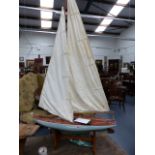 AN EARLY 20th.C.POND YACHT WITH FIBREGLASS HULL AND TWO SETS OF SAILS,ETC. L.93cms.