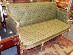 A REGENCY CARVED GILTWOOD SOFA WITH REEDED FRAME, FLUTED TAPERED LEGS ENDING IN BRASS CASTORS. W.162