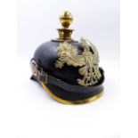 A GERMAN PICKLHAUBE HELMET WITH BLACK LEATHER SKULL AND BALL FINIAL.