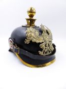 A GERMAN PICKLHAUBE HELMET WITH BLACK LEATHER SKULL AND BALL FINIAL.