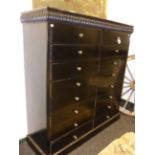 A 19th.C.EBONISED SIXTEEN DRAWER TALL CHEST WITH RIBBED CORNICE ON PLINTH BASE. H.152 x W.144 x D.