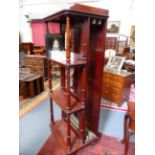 A VICTORIAN MAHOGANY FOUR TIER WHAT NOT/LEAF HOLDER CABINET ON RING TURNED SUPPORTS WITH BRASS