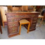 A LATE VICTORIAN OAK KNEEHOLE DESK WITH FOLIATE CARVED DECORATION. W.112cms.