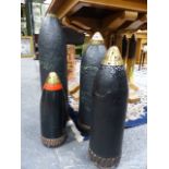 A GROUP OF FOUR HEAVY ARTILLERY PROJECTILES, EACH TIMED FUSE NOSE COVERS, LARGEST H.60 x D.14cms.