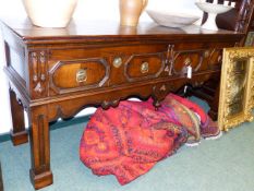 AN EARLY OAK TWO DRAWER DRESSER BASE WITH PANELLED WALNUT DRAWER FRONTS ON MOULDED SQUARE LEGS AND