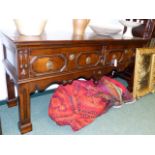 AN EARLY OAK TWO DRAWER DRESSER BASE WITH PANELLED WALNUT DRAWER FRONTS ON MOULDED SQUARE LEGS AND