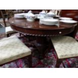 A VICTORIAN CARVED MAHOGANY EXTENDING DINING TABLE, CIRCULAR WHEN CLOSED (D.128cms) WITH TWO