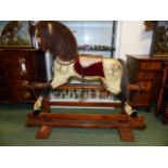 AN EARLY 20th.C.CARVED WOOD AND PAINTED ROCKING HORSE ON TRESTLE BASE. 91cms (HOOF TO EAR)