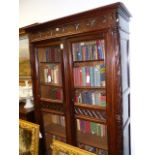 AN ANTIQUE FRENCH CARVED WALNUT BOOKCASE WITH GRILL PANEL DOORS ENCLOSING SHELVES, FOLIATE PILASTERS