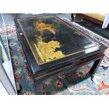 A CHINESE CHINOISERIE LACQUER PANEL MOUNTED AS A LOW TABLE. H.36 W.113 D.70cms.