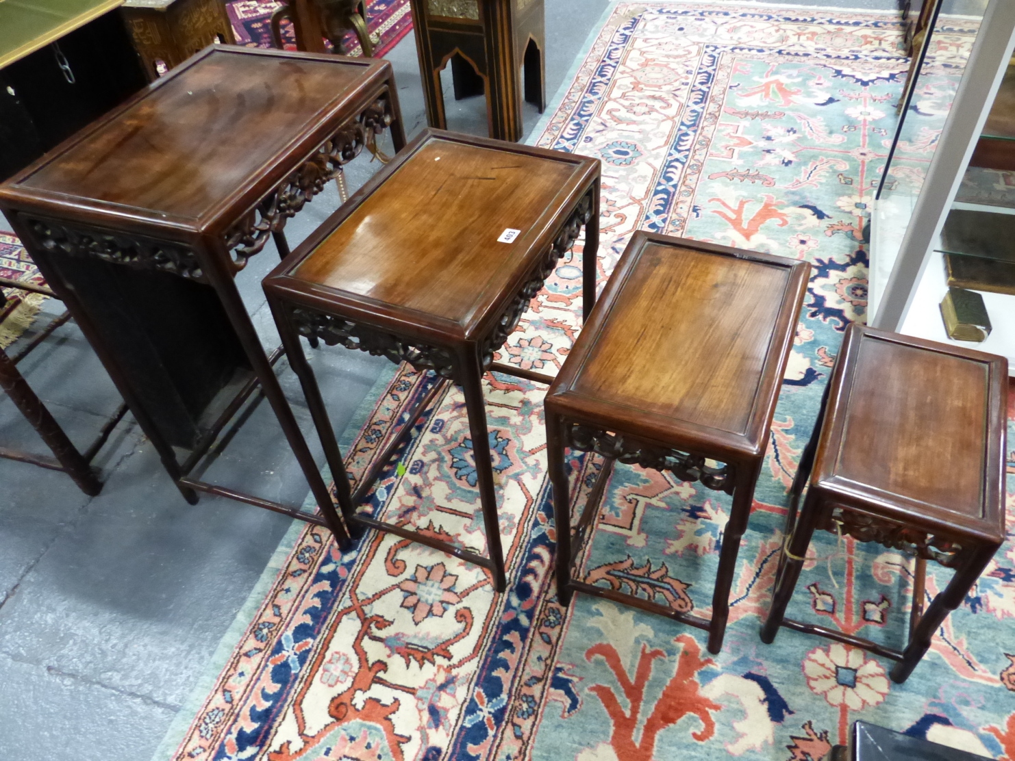 A NEST OF FOUR CHINESE CARVED HARDWOOD TABLES WITH PIERCED FOLIATE APRONS. - Image 2 of 19