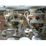 SIX EARLY 19th.C.URN FORM TWIN HANDLED VASES DECORATED IN THE IMARI PALETTE WITH GILT ACCENTS,