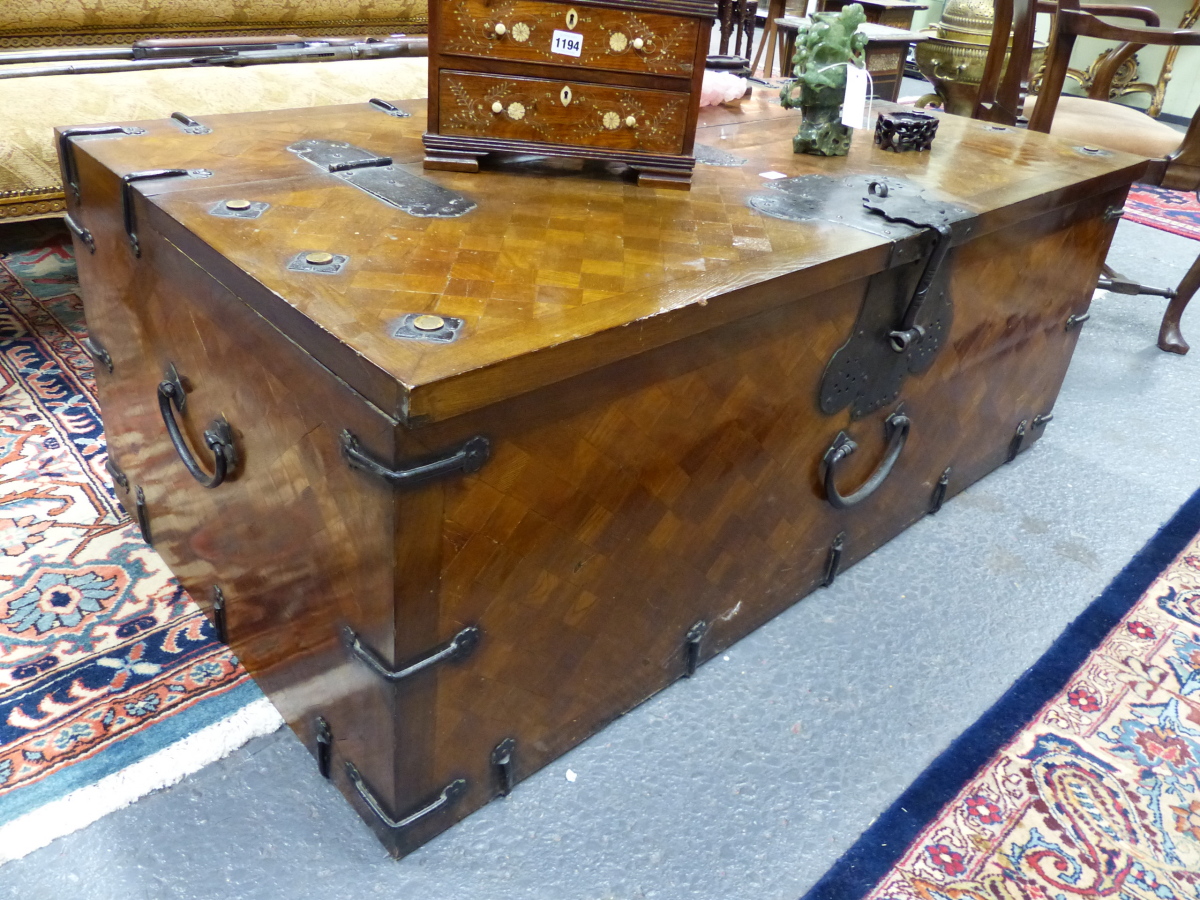 A LARGE ORIENTAL INLAID IRON MOUNTED COFFER WITH FLANKING CARRYING HANDLES. W.140 D.74 H.53cms.