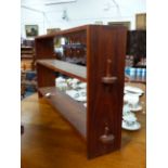 A TEAK COTSWOLD SCHOOL TWO SHELF LOW BOOKCASE. H.70 x W.138cms.