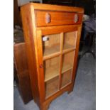 A SMALL COTSWOLD SCHOOL ARTS AND CRAFTS OAK GLAZED BOOKCASE. W.51 x H.104cms.