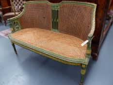 AN ANTIQUE FRENCH CARVED AND PAINTED LOUIS XVI STYLE CANE SEAT AND BACK SETTEE. W.130cms.