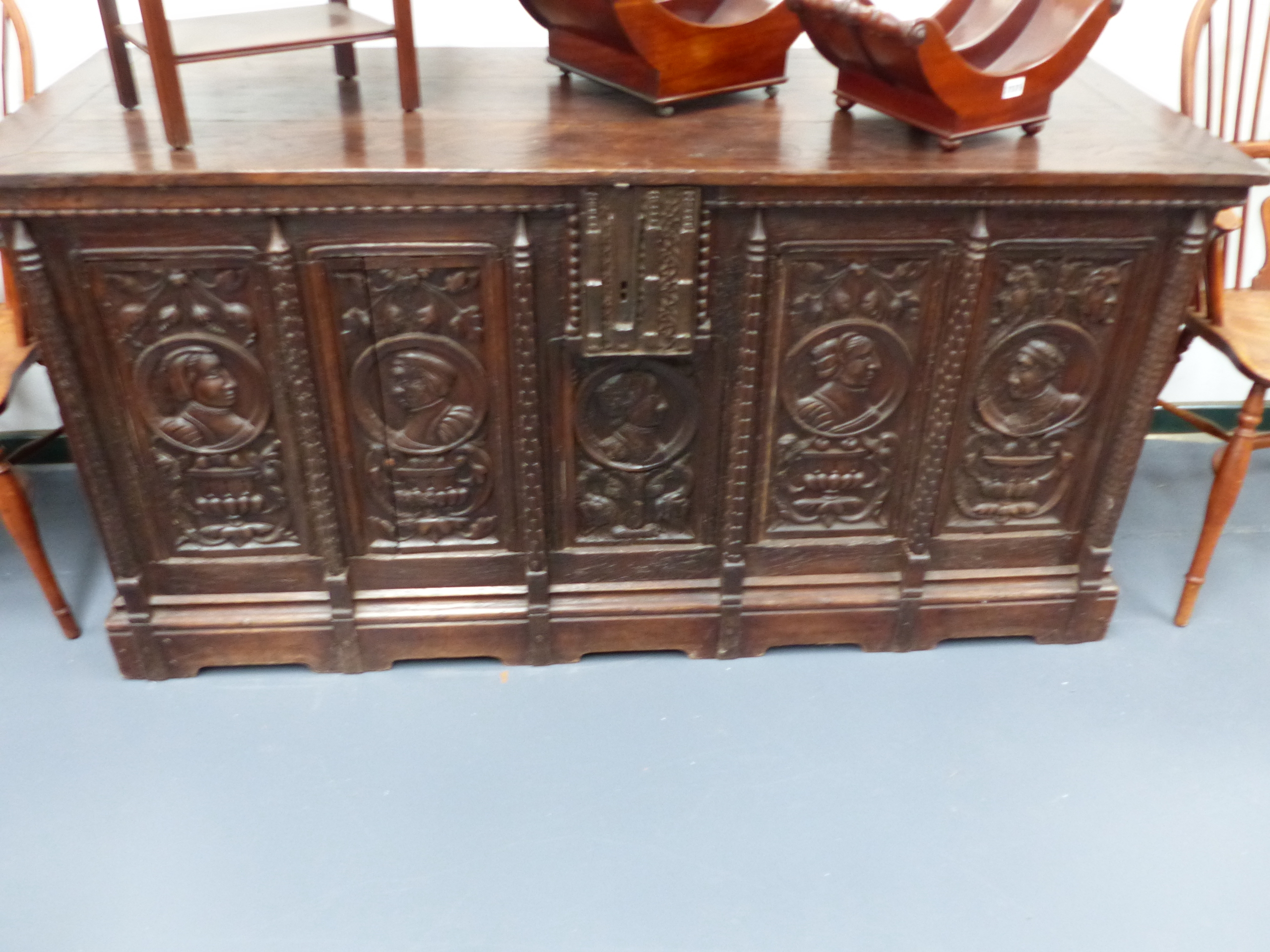 AN EARLY 17th.C.AND LATER LARGE OAK COFFER WITH CARVED PORTRAIT AND FOLIATE PANEL FRONT. W.170 x H.