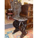 A 19th.C.ITALIANATE CARVED WALNUT HALL CHAIR WITH DOLPHIN FORM SUPPORTS AND CARVED FIGURAL BACK.
