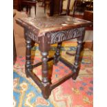 A 17th.C.AND LATER OAK JOINT STOOL WITH CARVED DECORATION. W.45cms