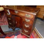 A MAHOGANY GEORGIAN KNEEHOLE DESK WITH MOULDED EDGE TOP ABOVE ONE LONG DRAWER AND TWO BANKS OF THREE