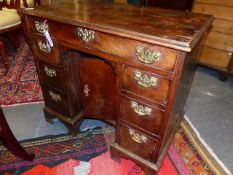 A MAHOGANY GEORGIAN KNEEHOLE DESK WITH MOULDED EDGE TOP ABOVE ONE LONG DRAWER AND TWO BANKS OF THREE
