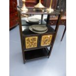 A VICTORIAN AESTHETIC EBONISED THREE TIER STAND WITH PAINTED PANEL DOORS. W.55 x H.97cms.