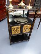 A VICTORIAN AESTHETIC EBONISED THREE TIER STAND WITH PAINTED PANEL DOORS. W.55 x H.97cms.