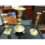 THREE ANTIQUE BRASS CANDLESTICKS AND A QUANTITY OF PEWTER PLATES.